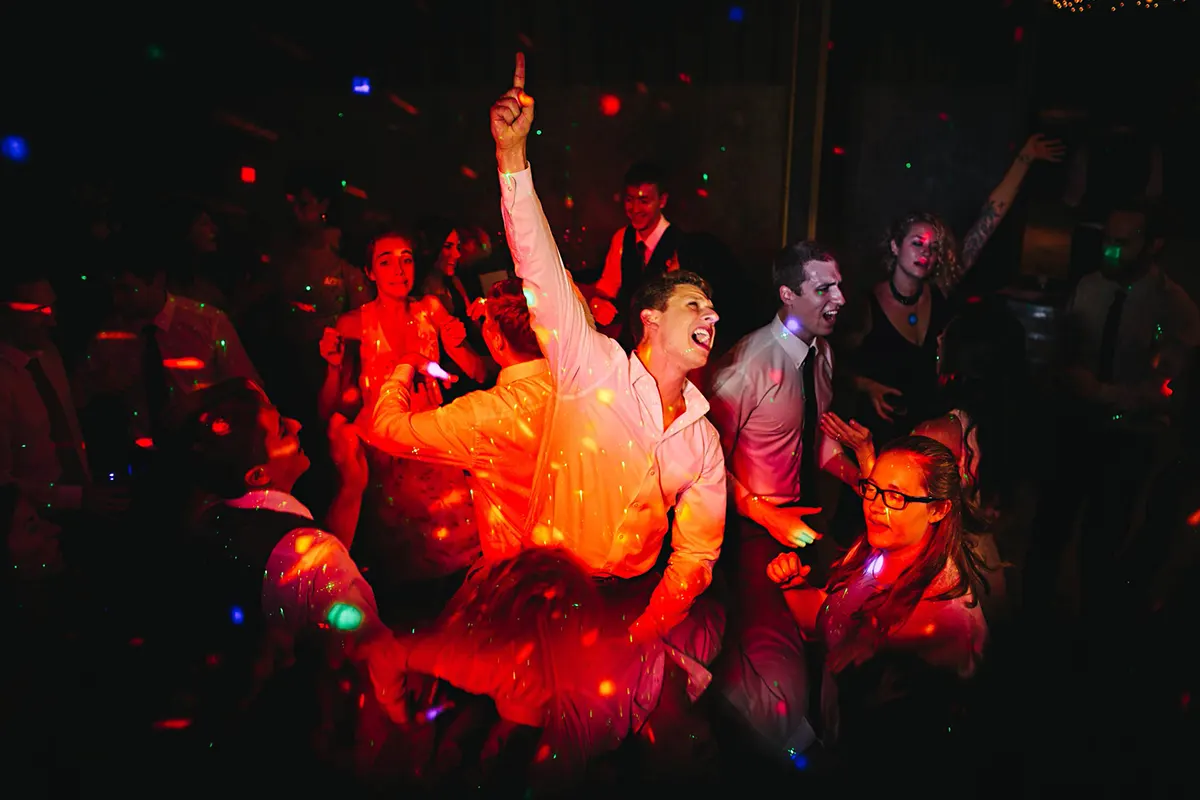 dance floor wedding dj grooms hand in the air